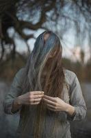 Close up woman in linen dress covering face with hair portrait picture photo