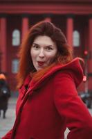 Close up surprised woman in bright coat on street portrait picture photo
