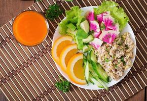 Dietary menu. Breakfast. Oatmeal porridge with vegetables and orange photo