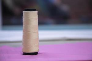 Spools of multicolor swings thread with Shallow depth of field photo