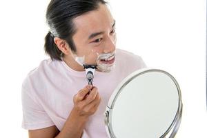 Serious guy shaving his beard photo