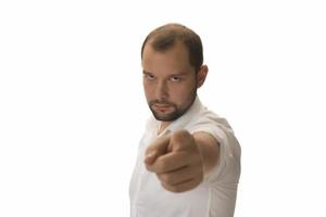 Portrait of young man pointing forward, looking at camera. Choosing someone concept photo