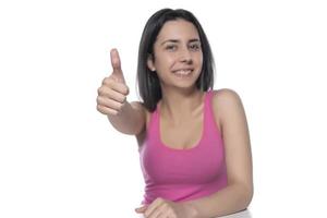 Closeup of female hand showing thumbs up sign against white background. photo