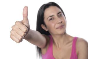 Closeup of female hand showing thumbs up sign against white background. photo
