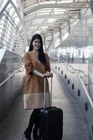 Portrait of beautiful woman, torism with travelling bag at airport preparing to travel in vacation
