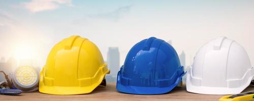 helmet on table with city background, protection and under construction building concept
