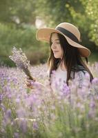 Beautiful young girl on lavender field. photo