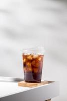 Iced americano on white wood table. photo