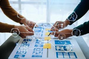 Close up view of UI developer team brainstorming on their project with laptop, smartphone and digital tablet. Creative digital development agency. VR icon photo