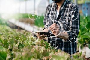 Smart farmer using application by tablet concepts modern agricultural technology and visual icon. photo