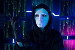 A Hacker is using laptop computer to steal data in the night photo