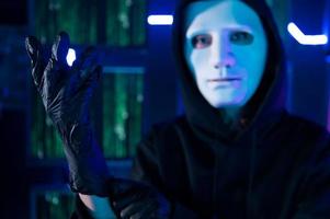 A Hacker is using laptop computer to steal data in the night photo