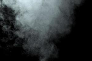 Abstract  powder or smoke isolated on black background photo
