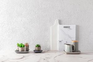 part of the interior of a modern kitchen countertop with white marble cutting boards and succulents in flower pots. minimalism. photo