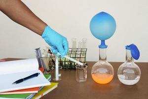 Student do science experiment, lab lesson, transparent bottles with inflated balloons on top of bottle. The experiment about air or gas reaction by using chemical substances. Education Science subject photo