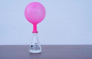 Science experiment , pink inflated balloon  on top of transparent test bottle. The experiment about air or gas reaction.by using baking soda and vinegar.Concept,  Science Education photo