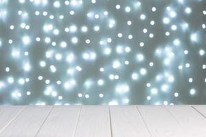 Abstract background, mockup. Defocused blue lights bokeh and white wooden surface photo