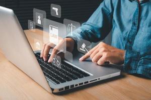 Female lawyer hand using laptop computer with holographic law icon on office desk, terrorism, crime, judgment, verdict, justice and law concept. photo