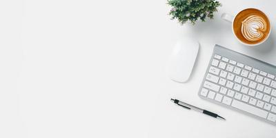 Office desk with keyboard, Pen, Cup of coffee on white background, Top view with copy space, Mock up. photo