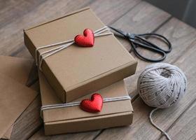 Valentine's Day gift wrapping. Kraft gift boxes decorated with red hearts photo