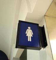 Real toilet sign or restroom direction tab. photo