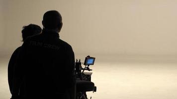 Behind the scenes of silhouette working people that making movie. photo