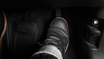 Close up foot press or push foot break and accelerate pedal of a car to drive ahead. photo