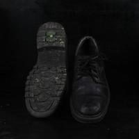 Pair of black male classic shoes on black background. Dusty shoes photo