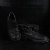 Pair of black male classic shoes on black background. Dusty shoes photo