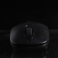 Black computer mouse on black background photo