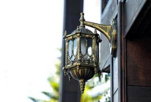 wall lamp, home decoration lamp European style, golden rust color Install it outside the house for beauty and lighting at night. Soft and selective focus. photo