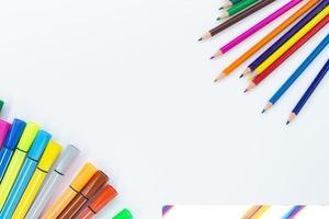 https://static.vecteezy.com/system/resources/thumbnails/017/340/823/small/back-to-school-from-the-corners-there-are-colored-pencils-on-the-other-hand-markers-or-felt-tip-pens-on-white-background-with-place-for-text-learning-concept-copy-space-photo.jpg