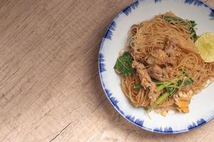 Fried noodles with black sauce with pork and vegetables photo