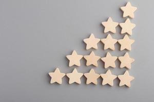 Five wooden stars on gray background.Copy space. photo