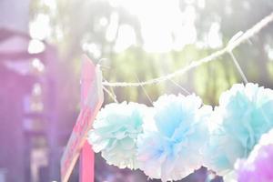 delicate colored summer background shot at sunset with handmade paper flowers photo
