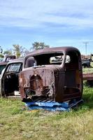 an old truck cab in a scrap yard photo