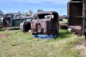 an old truck cab in a scrap yard photo