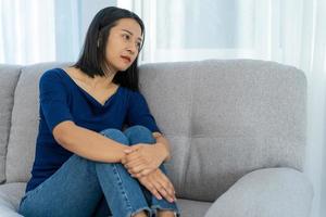 Depression and mental illness. Beautiful Asian woman disappointed and sad after receiving bad news. Stressed girl confused with unhappy problems in life, arguing with her boyfriend. photo