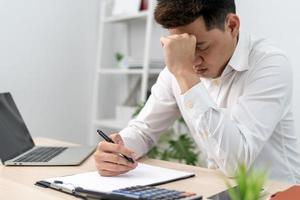 Men sit stressed with problems inside the office. A man is sad and disappointed is lonely. Loneliness and disappointment with life and business. photo