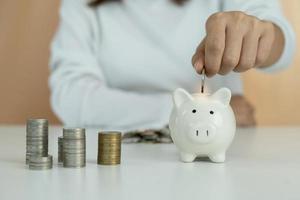 Piggy bank with a pile of coins. Women owe credit cards are calculating all expenses and liabilities. debt concept photo