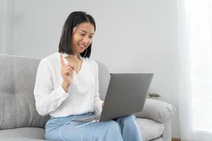 Online job interview. Asian businesswoman is being interviewed for a job with an executive via video call. Talk about past work experience and competence in the position. resume or personal record photo