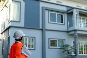 Inspector or engineer is checking and inspecting the building or house by using checklist. Engineers and architects work on building the house before handing it over to the landlord. photo