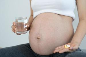 Pregnant women consume vitamins and folic to nourish the pregnancy. Healthy pregnancy for baby. photo