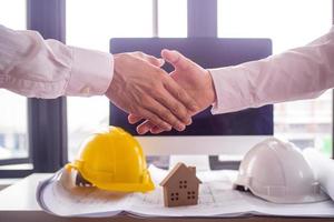 The construction team leader is going to shake hands with the leader engineer, start the construction site improvement project, cooperation and contractor. photo