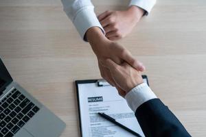 Businessmen and job seekers shake hands after agreeing to accept a job and approve it as an employee in the company. Or a joint venture agreement between the two businessmen photo