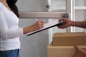 The sender holds a box prepared to deliver to the commander and sign the recipient in the board. photo