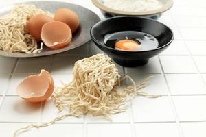 Raw Egg Noodle on White Table photo