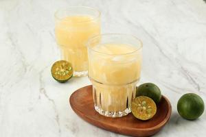 Es Kelapa Jeruk or Fresh Coconut Orange, Indonesian Typical Drink photo