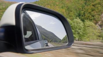 View from the inside of a driving car along the highway to the side mirror during the rain. The concept of vehicles and drivers. No people. video