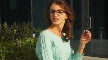 young woman wears reading glasses in the street video